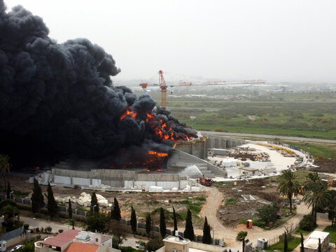 Acre, Israel - April 8 2022: Bahai construction site caught fire and huge smoke pillar covering residential neighborhood 