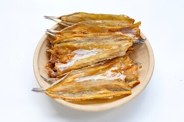 Sun dried black kingfish on white background.