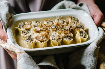 Cannelloni with mushroom stew and chestnuts. Author's Corsican cuisine. Cannelloni in a baking dish