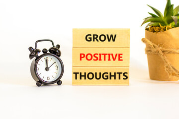 Grow positive thoughts symbol. Concept words Grow positive thoughts on blocks. Beautiful white...