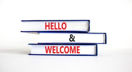 Hello and welcome symbol. Concept words Hello and welcome on books. Beautiful white table white...