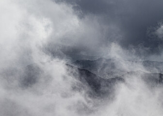 violent storm in california mountains sierra with swirling clouds and fog