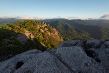 Morning light illuminating the rocky summit of Old Rag Mountain during a springtime sunrise.