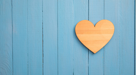 Wooden heart on wooden background.