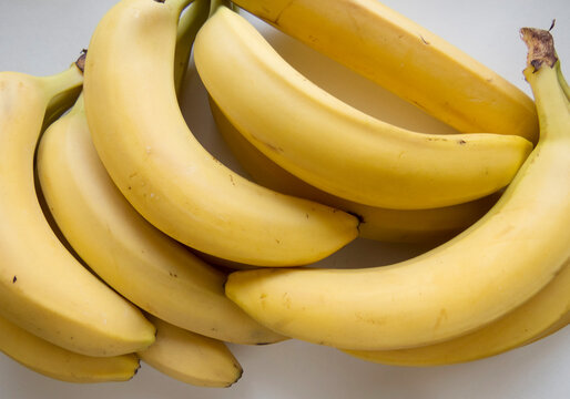 Banana bunch and peeled pieces  photo Tropical fruits, banana snack or vegetarian nutrition.  Top view
