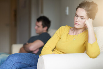 Time for the silent treatment. Cropped shot of an unhappy young couple sitting on the couch at home...