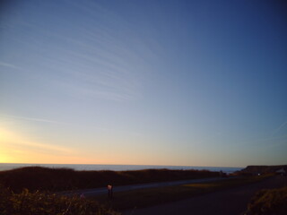 Naklejka na ściany i meble Dusk, sunset sundown, blue sky airplane trails sea coast