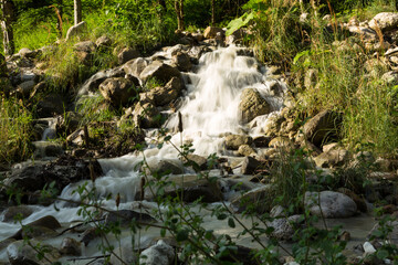 waterfall in the mountains of Chechnya in the spring in a picturesque forest