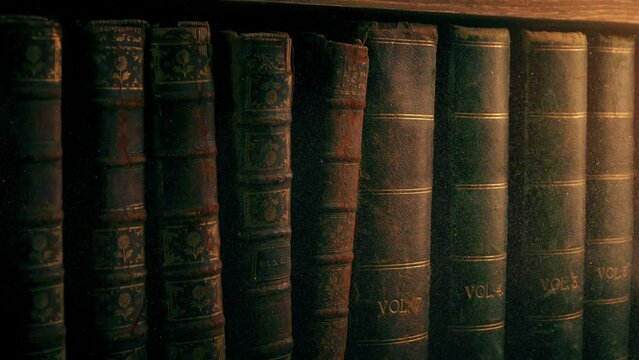 Passing Old Books With Dust Swirling In Warm Lighting