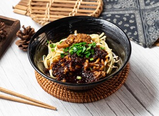 Big Chili Sauce Noodles in a dish isolated on wood table side view taiwan food