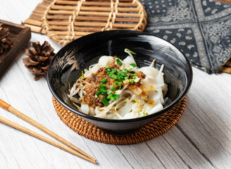 Big Kway Teow dry in a dish isolated on wood table side view taiwan food