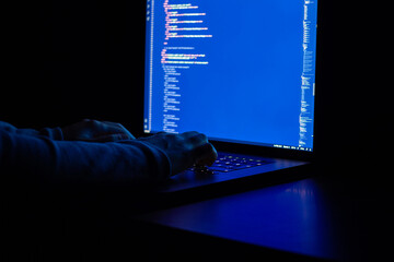 Woman engineer writes javascript code at night