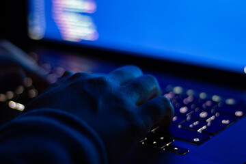 Developer who types code at night. Close-up focused on hands