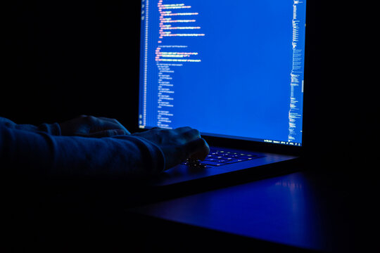 Woman engineer writes javascript code at night