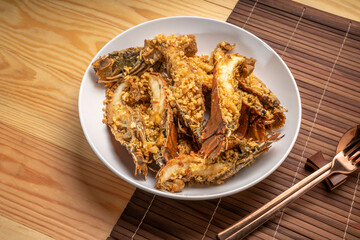 Stir fried flathead lobster with garlic and pepper on wooden table, Fried flathead lobster with garlic.