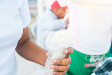 Closeup of the hands of a Nicaraguan woman holding a traditional dish called quesillo