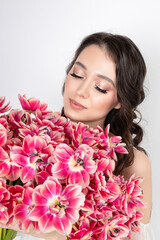 Girl with a bouquet of pink tulips. Girl with a gift of flowers