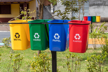 Set of bins for the selective collection of waste (metal, glass, paper, and plastic), in...