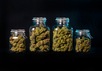 Dried cannabis buds stored in a glass jar - 497983916