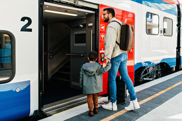 Happy family, father and son get together on the train.