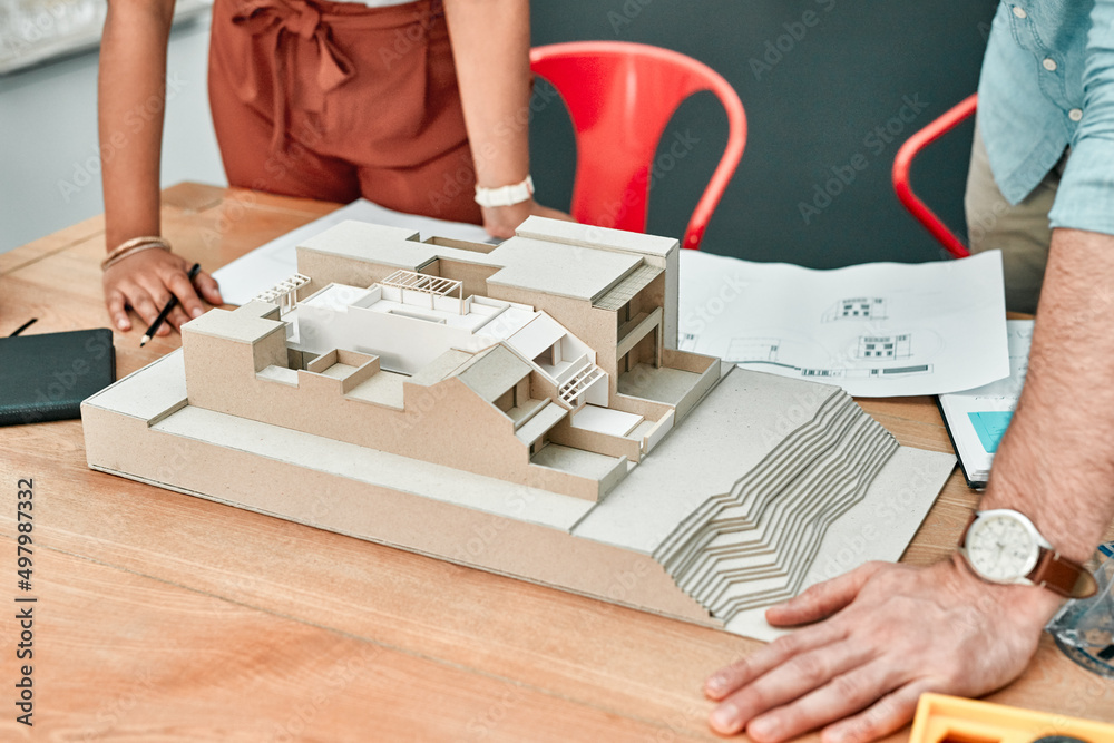 Aufkleber Designing their dreams is part of the job. Closeup shot of two architects working together on a scale model of a building in an office.