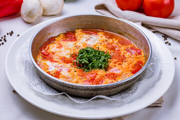 shakshuka classical on cast iron pan on white plate