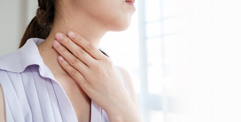 Woman with sore throat inflamed tonsils from influenza symptoms. Healthcare and medical concept