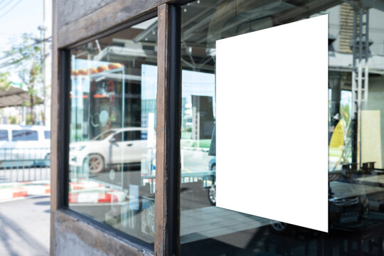 Mockup white paper or white sticker poster displayed on the front of the restaurant, coffee shop, Promotion information for marketing announcements and details
