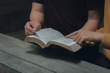 Men and women are studying the same Bible. bible background