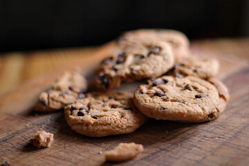 Delicious chocolate cookies placed on a wooden table