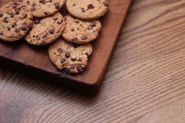 Delicious chocolate cookies placed on a wooden table