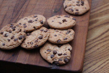 Delicious chocolate cookies placed on a wooden table