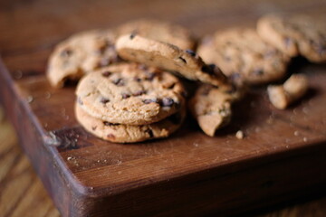 Delicious chocolate cookies placed on a wooden table