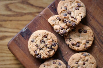 Delicious chocolate cookies placed on a wooden table