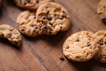 Delicious chocolate cookies placed on a wooden table