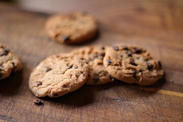 Delicious chocolate cookies placed on a wooden table