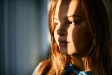 Close up of pensive redhead teenage girl.