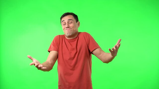 Brunet looking at camera standing on chromakey with thumb down