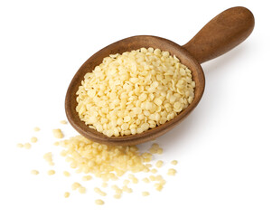 Raw hemp seeds in the wooden spoon, isolated on the white background.