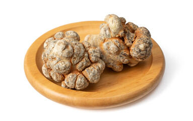 Dried notoginseng roots in the wooden bowl, isolated on the white background.
