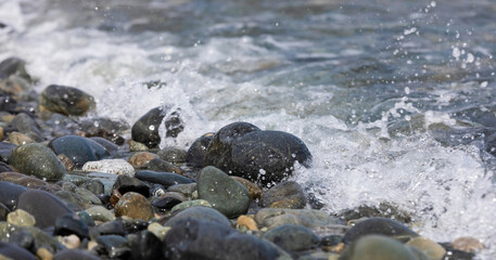Beach stones soaking in the waves
