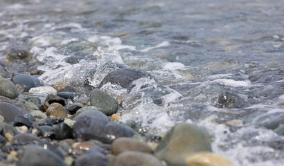 Beach stones soaking in the waves