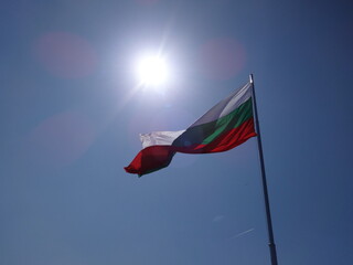 The Flag of Bulgaria against the Background of the Blue Sky