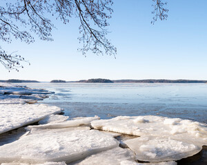 Winter coastal landscape with big floating ice