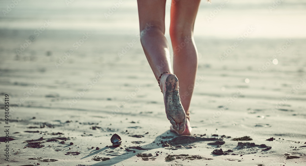 Sticker Letting her feet guide her. Cropped shot of an unrecognizable woman walking on the beach.