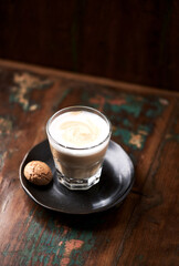 Coffee with milk on rustic wooden background. Soft focus. Close up. Copy space.	