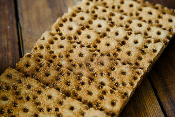 Rye crispbread. Crispy dry bread. Crispbread for sandwiches. Bread replacement. Wooden background. Side view.