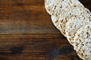 Obraz na płótnie Canvas Rice crispbread. Rice crispy dry bread. Crispbread for sandwiches. Bread replacement. Wooden background. side view. Copy space