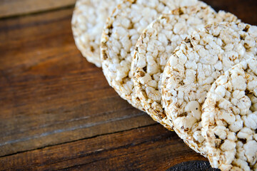 Rice crispbread. Rice crispy dry bread. Crispbread for sandwiches. Bread replacement. Wooden background. side view. Copy space