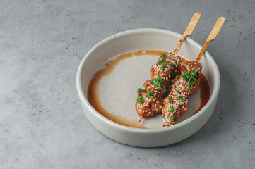 Kushiyaki, japanese skewered and grilled pork on gray background